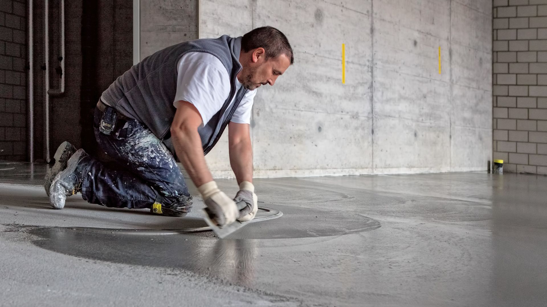Man applying SikaScreed on floor